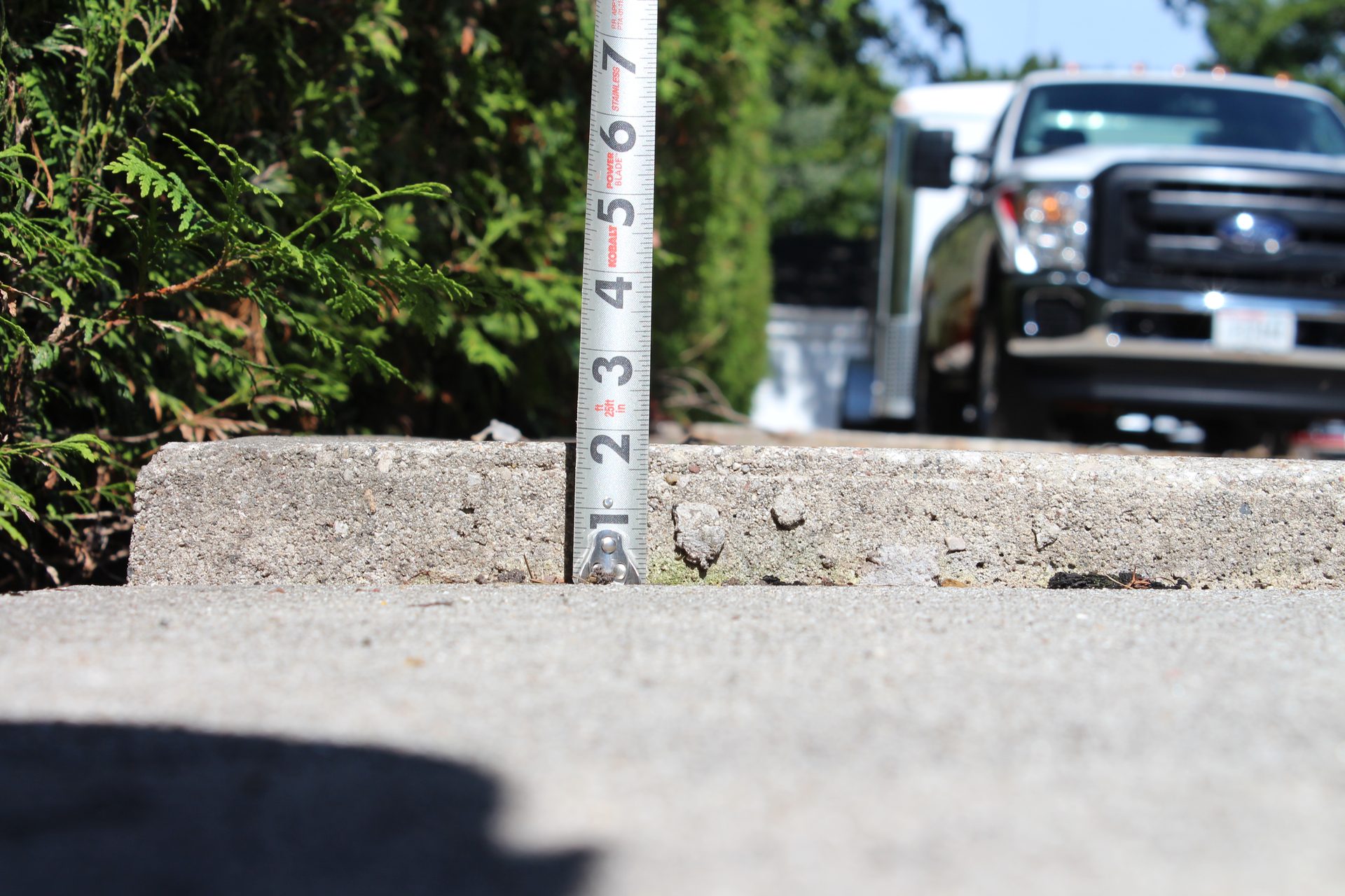Raised uneven sidewalk panel before polyurethane foam concrete lifting